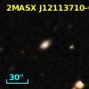 2MASX J12113710-0343389
